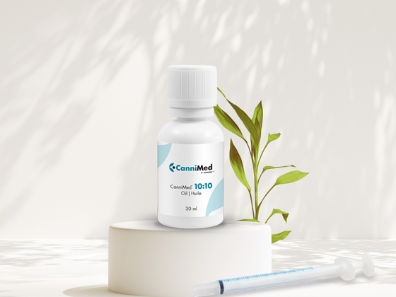A bottle of balanced cannabis CanniMed 10:10 oil with a syringe